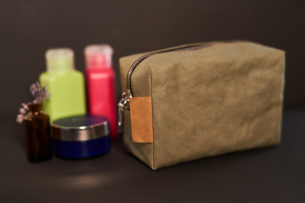 Travel cosmetic bag with colored toiletry plastic bottles